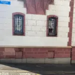 a building with windows and a street sign